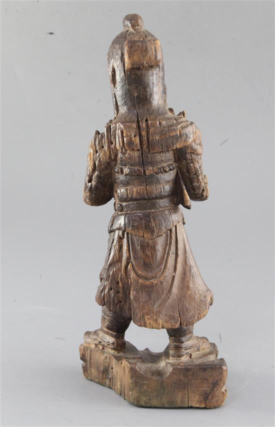 A Chinese carved wood figure of a warrior, Ming dynasty, height 31.2cm, old losses and age cracks